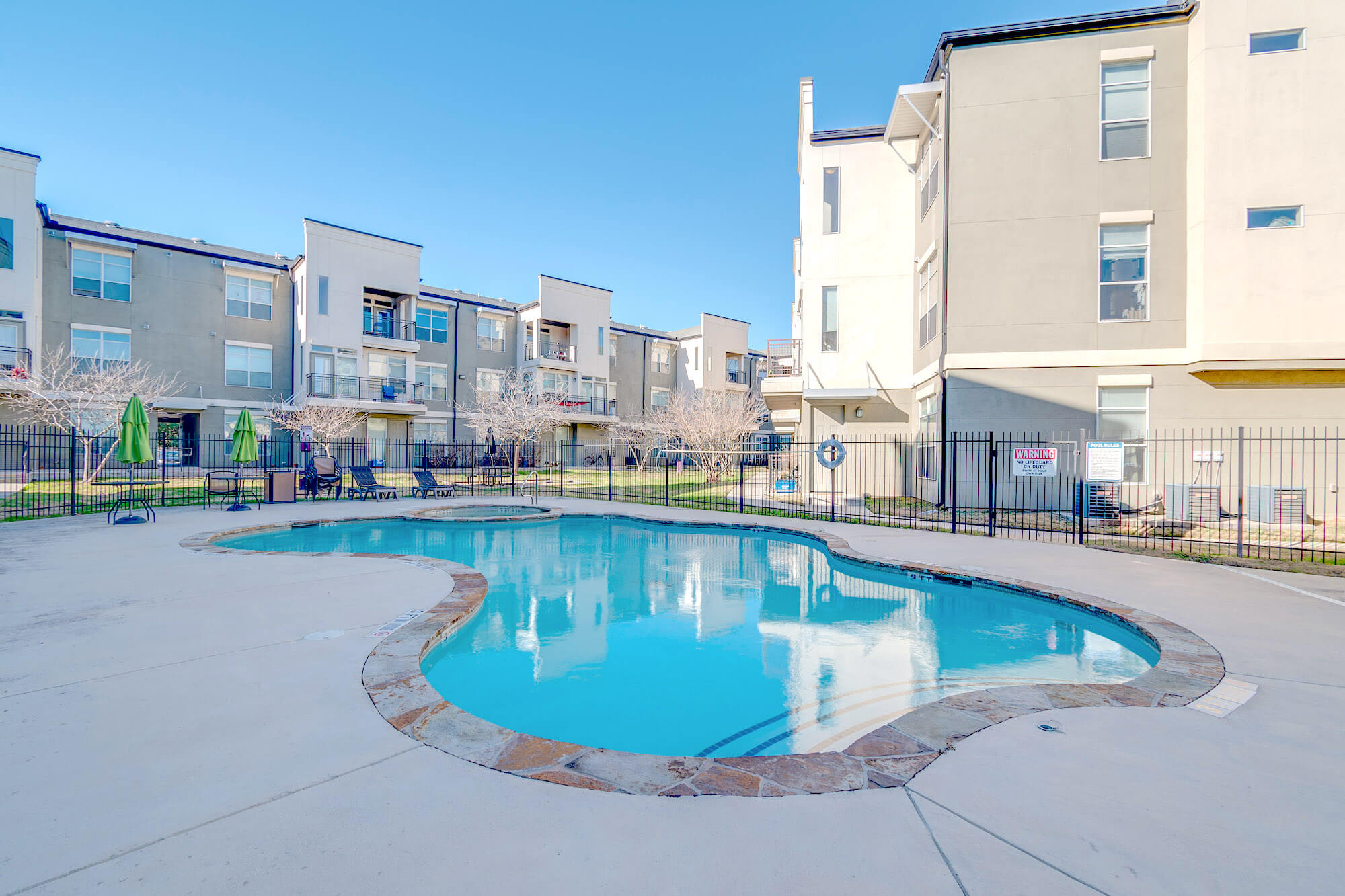 The Millennium on Post pool surrounded by buildings and community space.