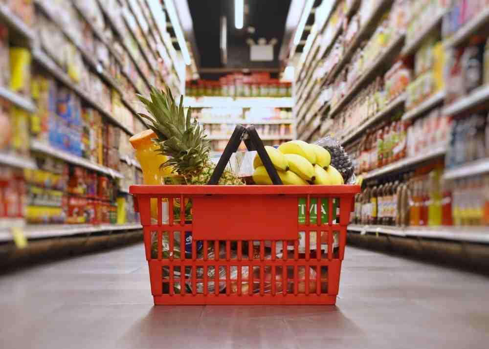 A grocery basket full of fruits and vegetables.