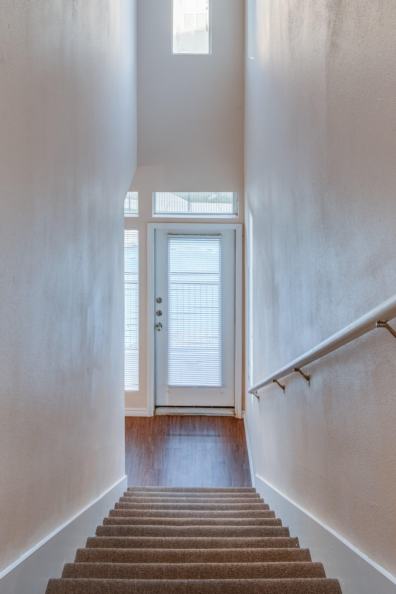 The stairwell to the front door for second-floor units.