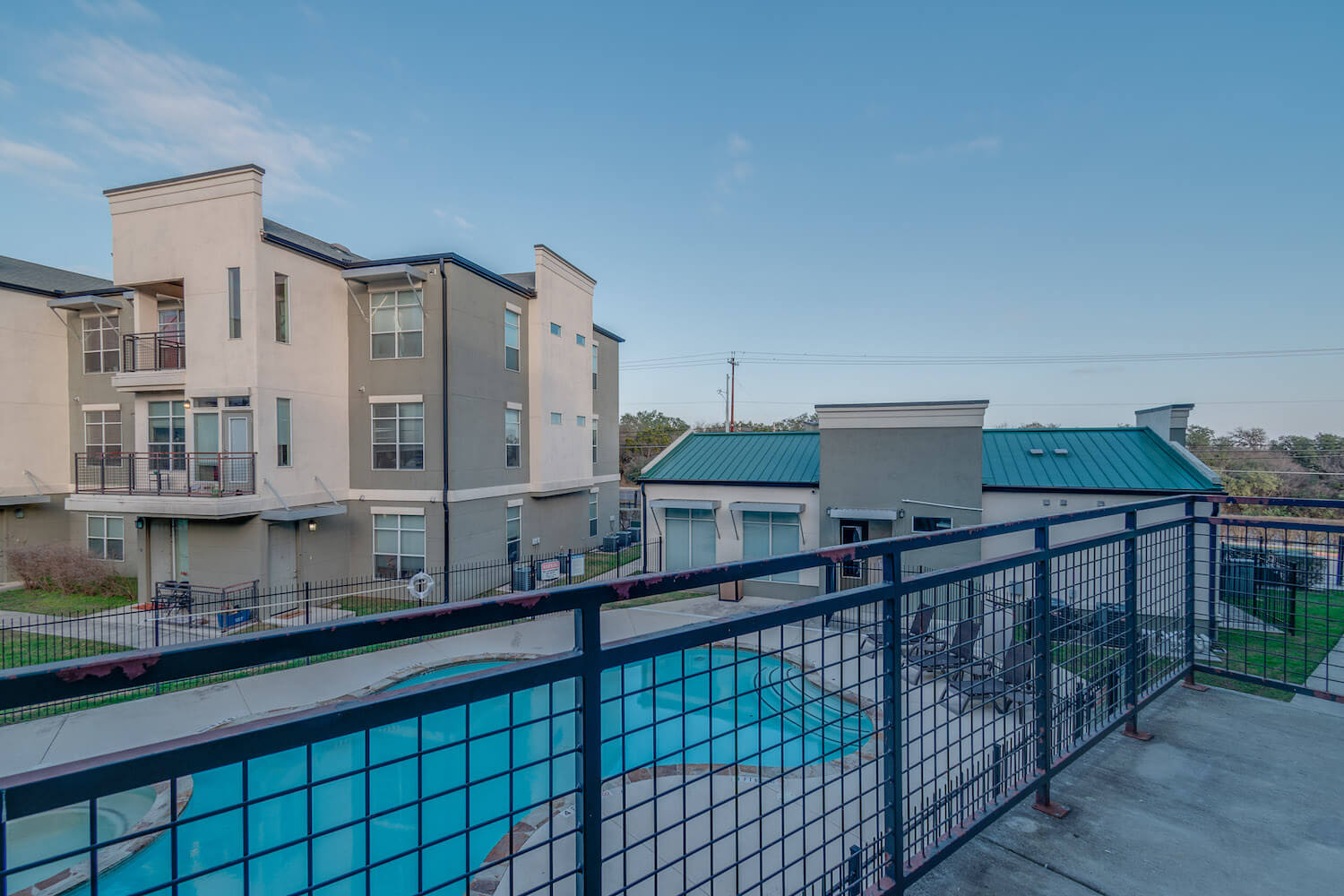 A balcony overlooking the sparkling pool.