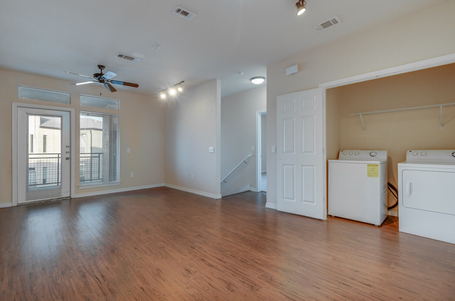 A living room featuring a closet for a washer and dryer.